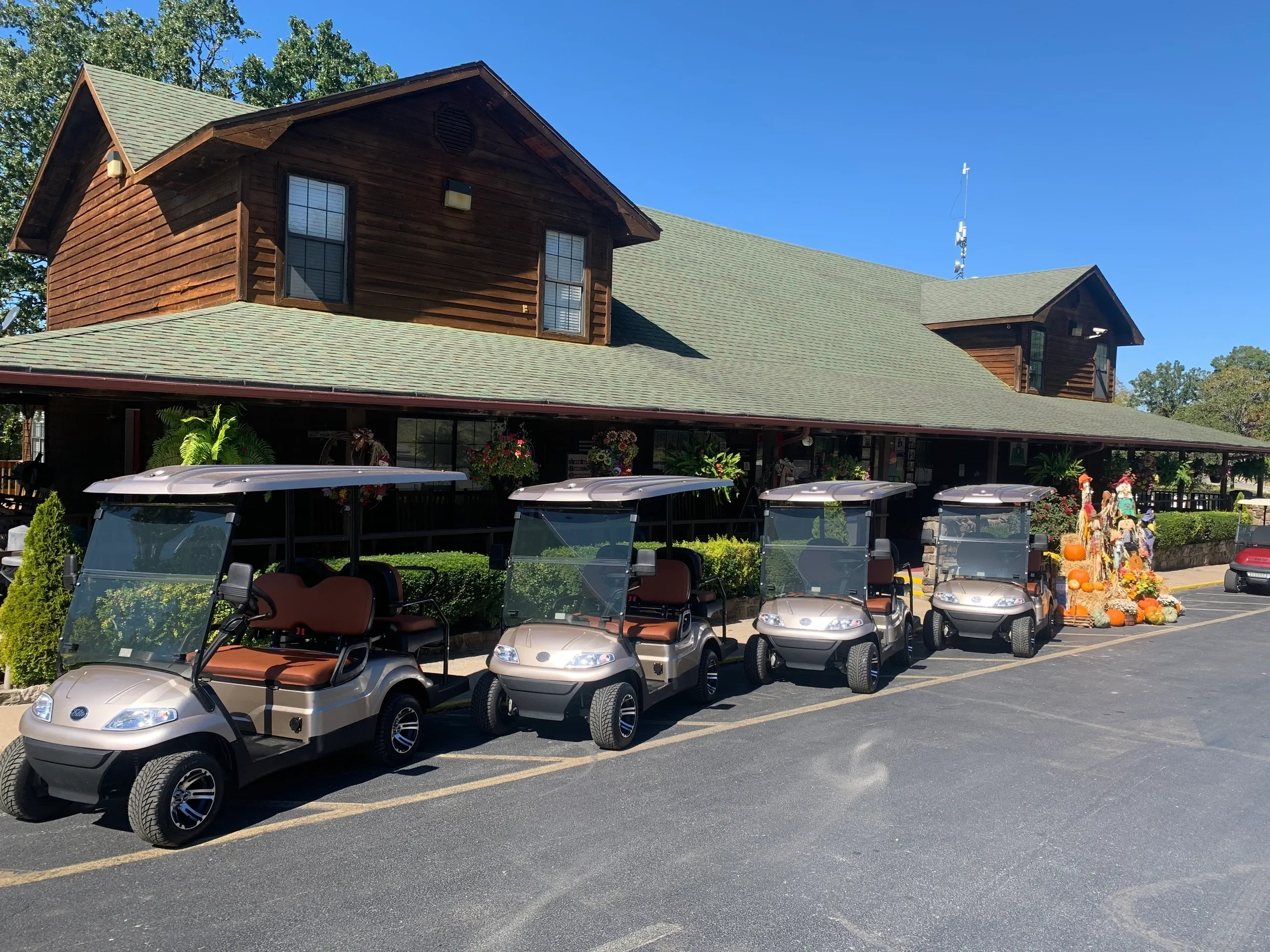 A row of golf carts parked in front of a building