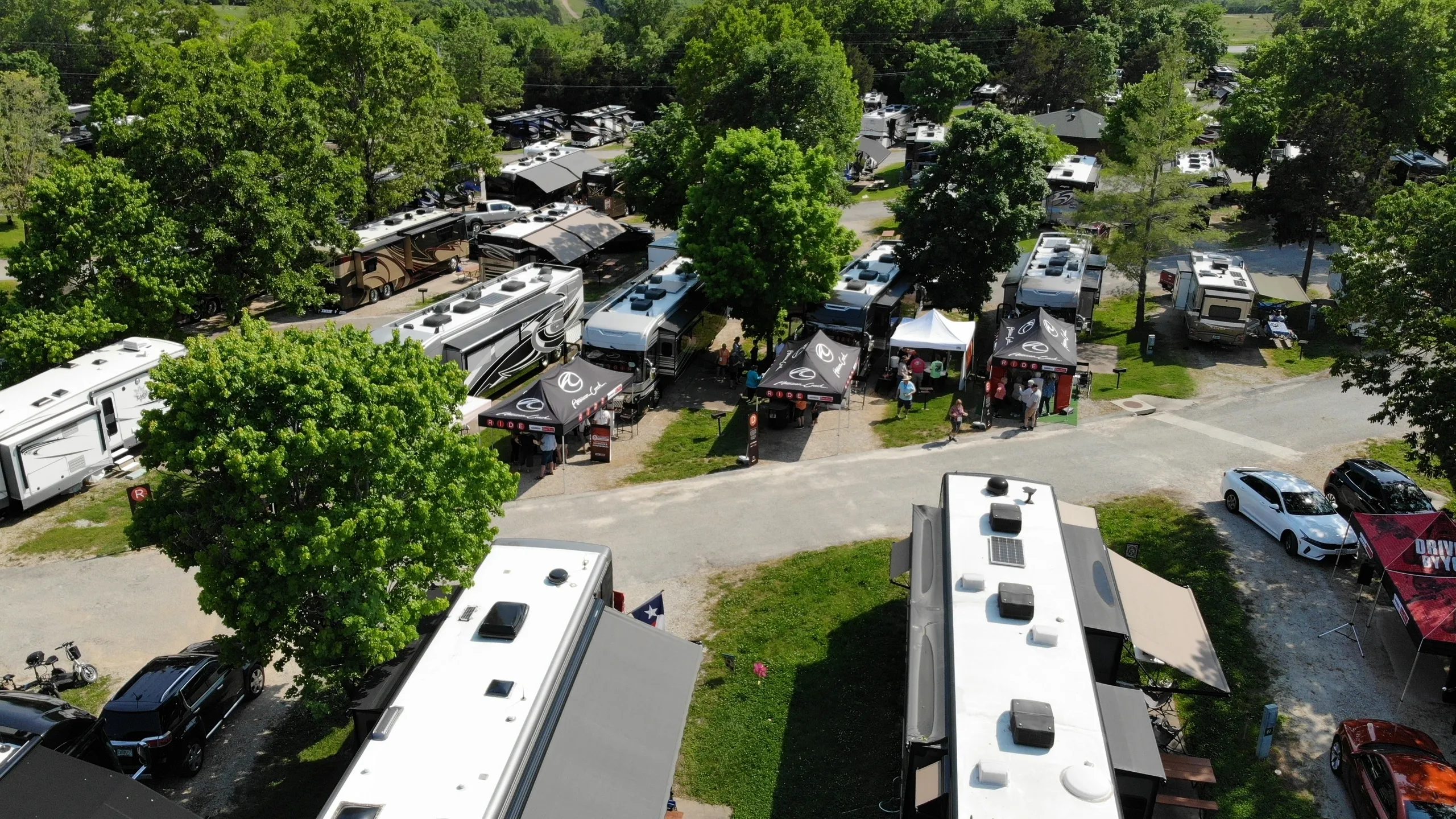 A campground with numerous RVs parked in a row