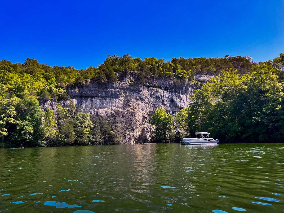 A white boat is floating on a body of water