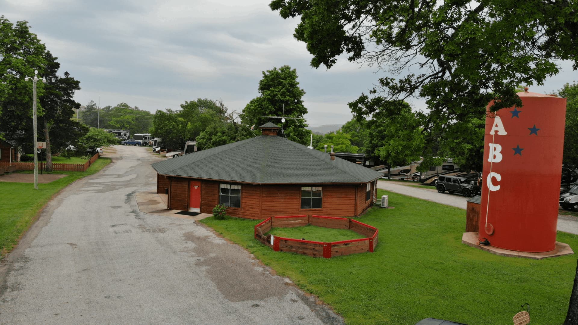 A small brown building with a red door and a black roof