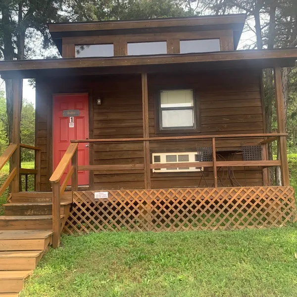 A red door on a wooden cabin
